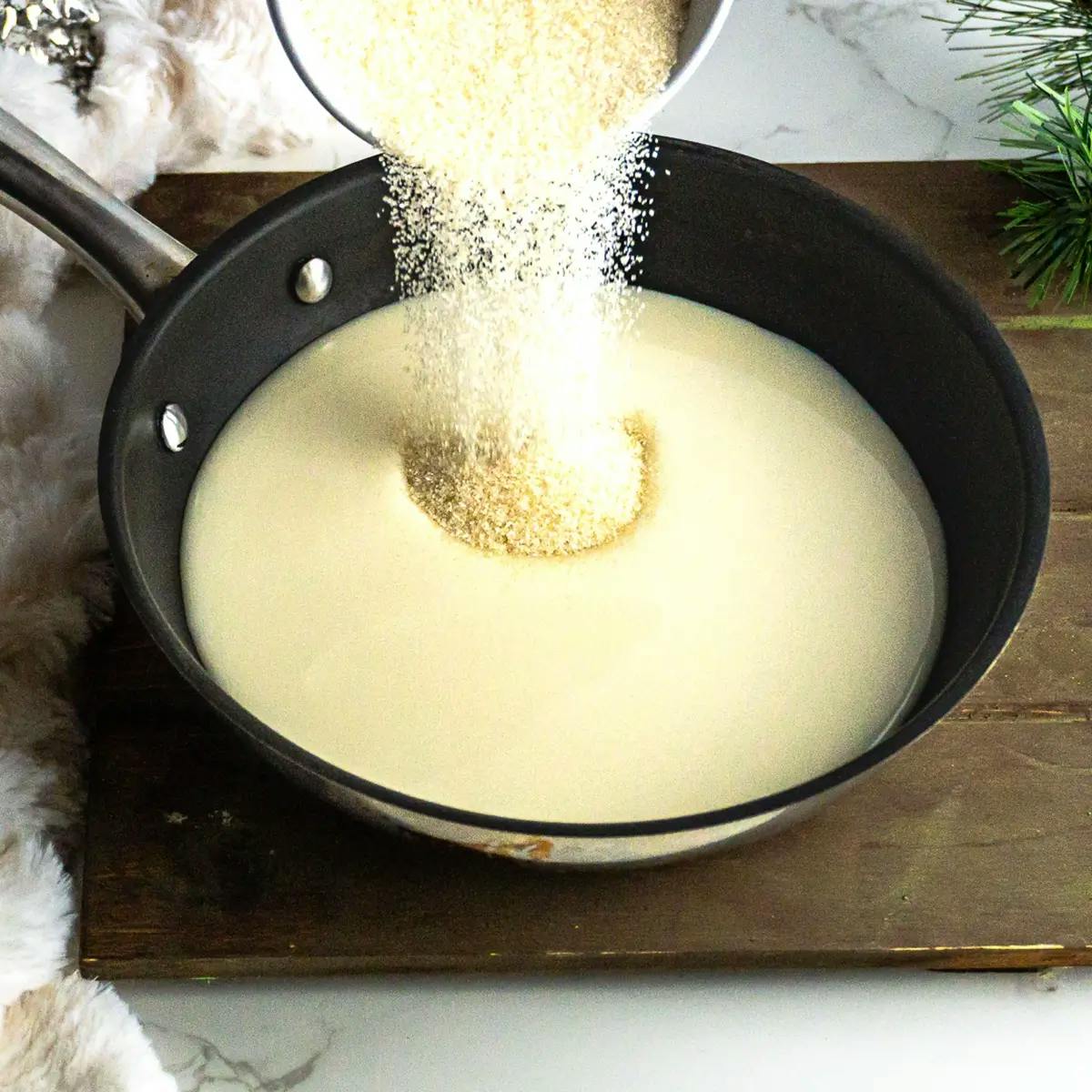 Heating milk and sugar in a recipe for vegan vanilla pudding.