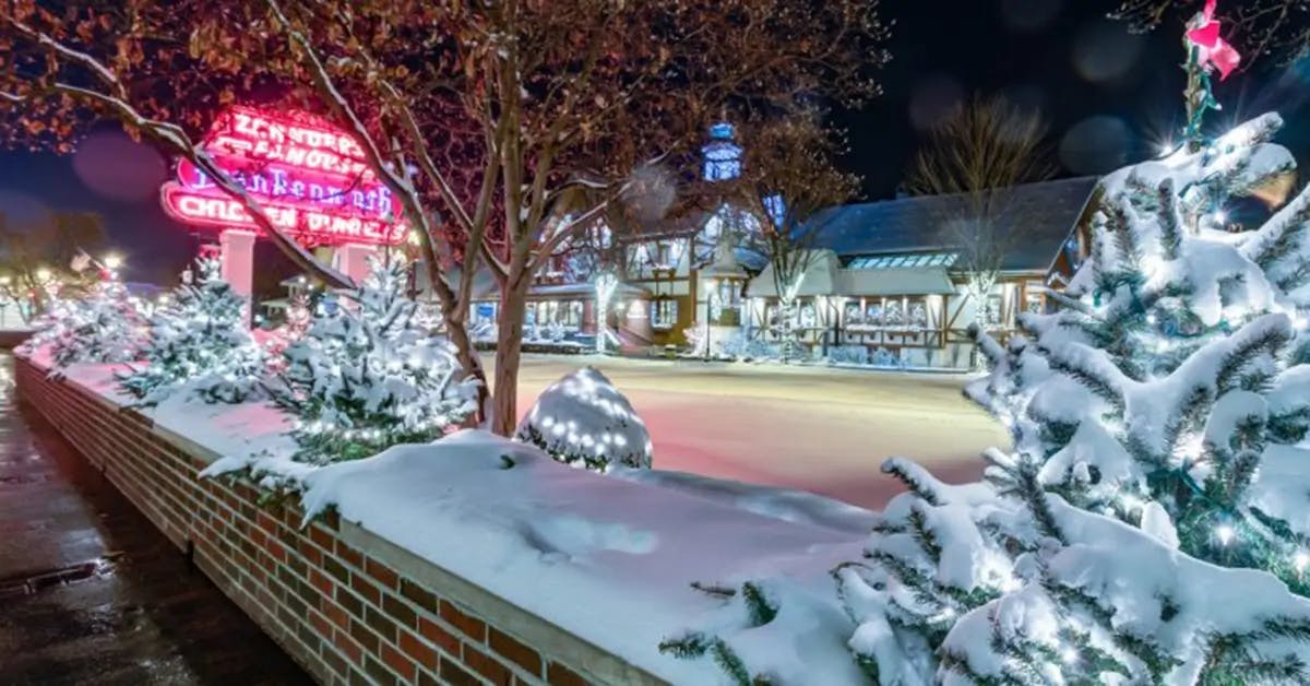 Snow-covered Bavarian street lit with Christmas lights in Frankenmuth, MI.