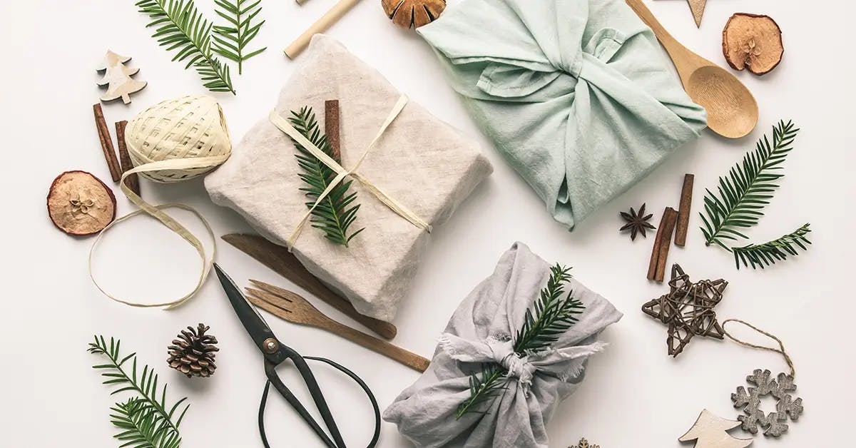 Holiday gifts wrapped in eco-friendly cloth and decorated with sustainable twine.