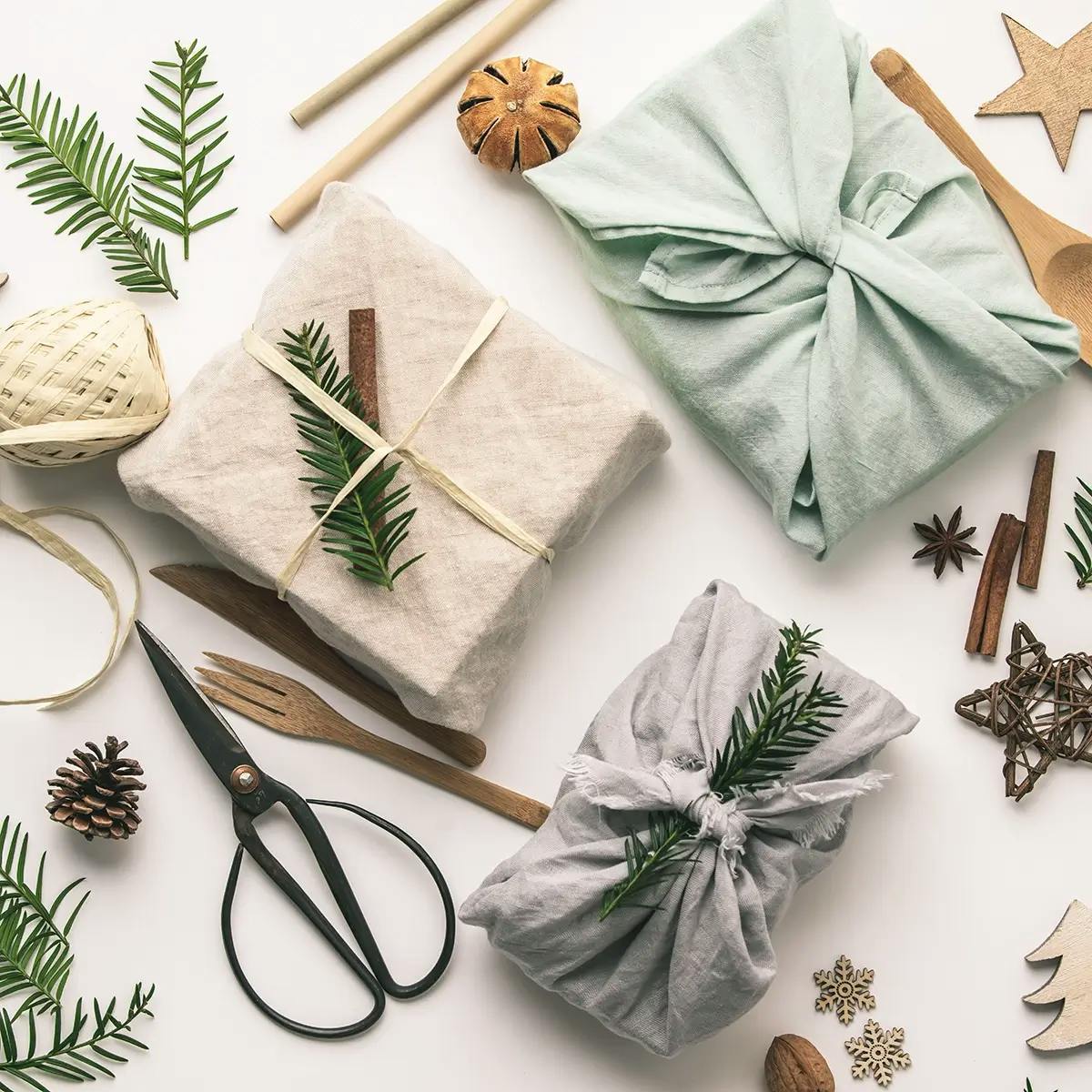 Holiday gifts wrapped in eco-friendly cloth and decorated with sustainable twine.