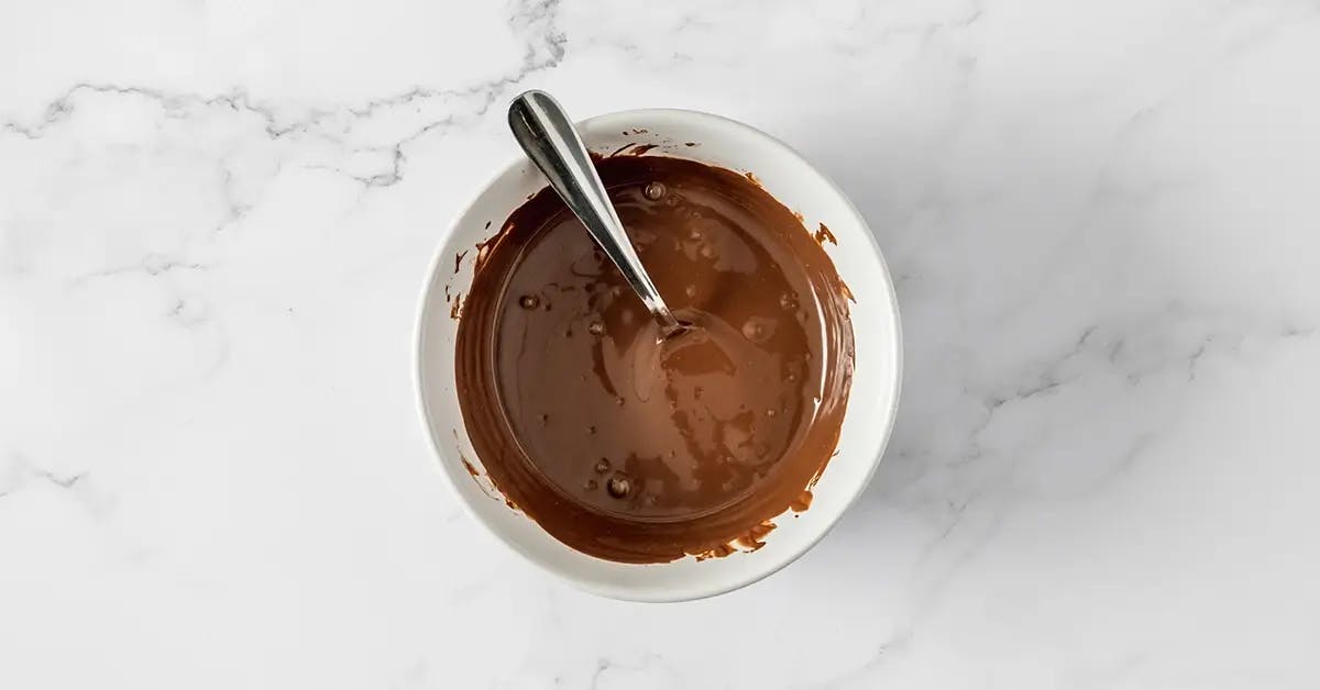 Melting chocolate in a bowl, ready to make Reindeer Cookie Dough Bites.